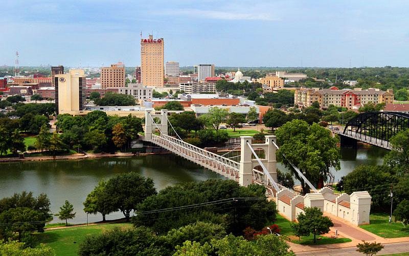 Aerial view of Waco, Texas and the suspension bridge over the Brazos River at sunset